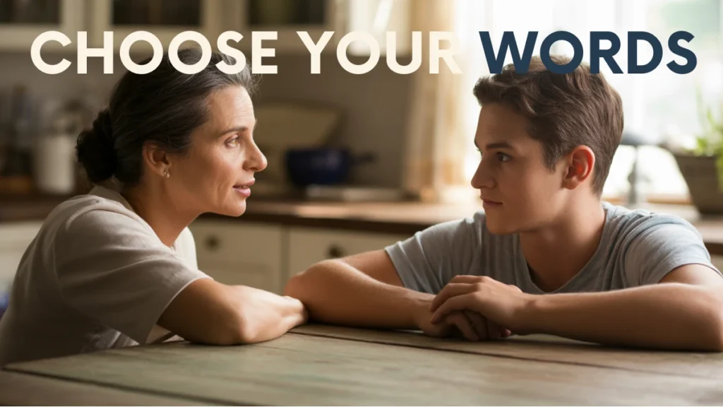 Two people at a kitchen table; one listens with care during a difficult conversation.